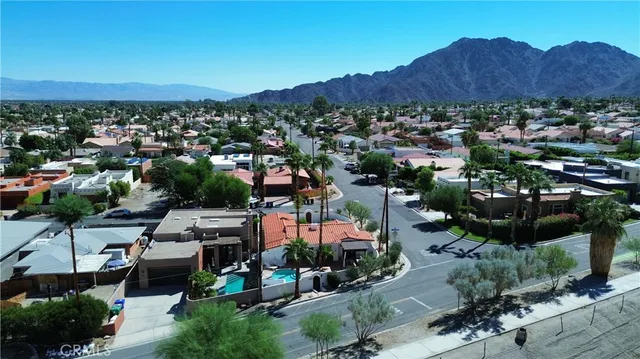 an aerial view of a house with garden space and street view