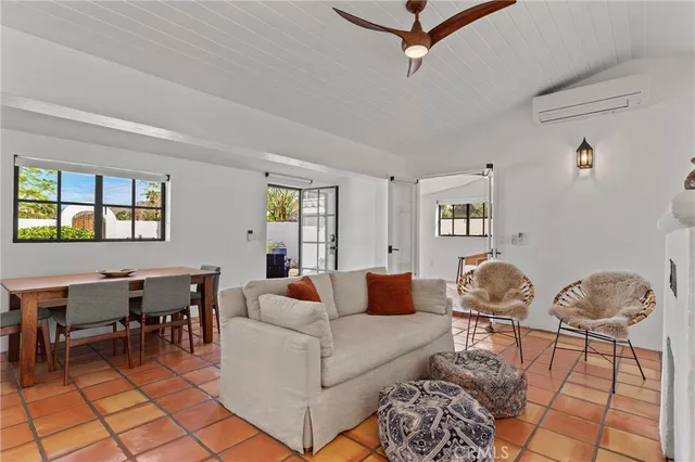 a living room with furniture a rug and a window