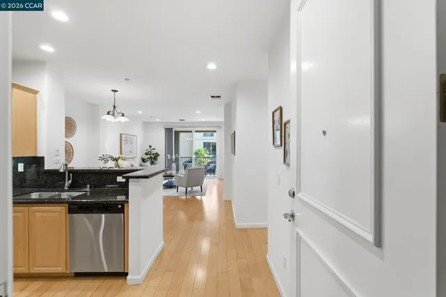 a kitchen with stainless steel appliances kitchen island granite countertop a stove a sink and a refrigerator