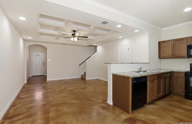 a view of a kitchen with a sink and a ceiling fan