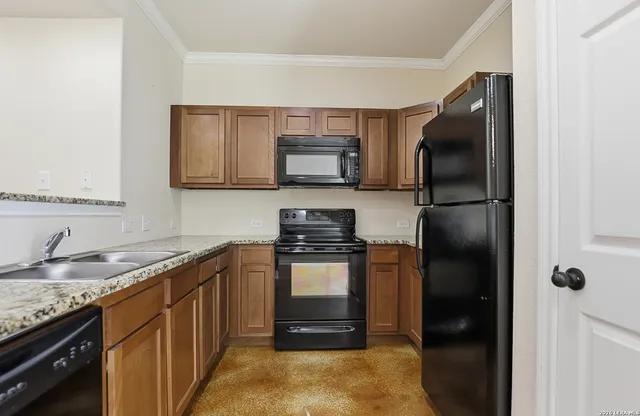 a kitchen with a refrigerator stove and sink