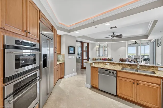 a kitchen with a sink and stainless steel appliances