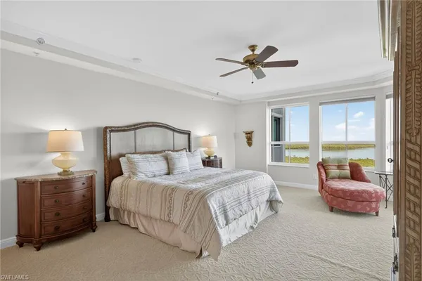 a bedroom with a bed a couch and a window