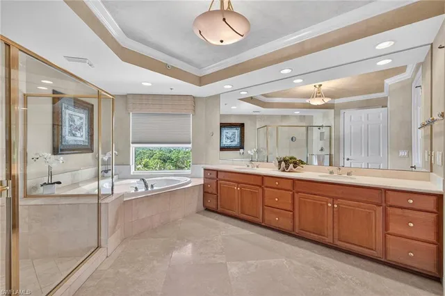 a large bathroom with a large tub and sink