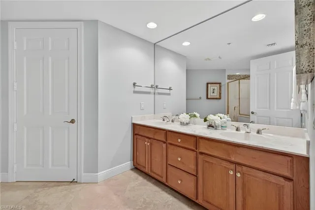 a bathroom with double sink and a mirror
