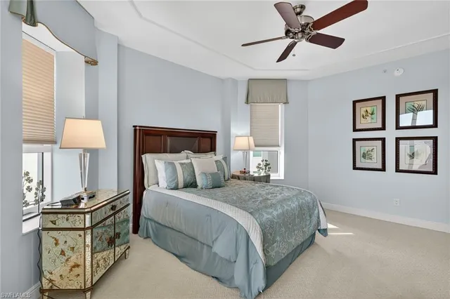 a bedroom with a bed and painting on the wall