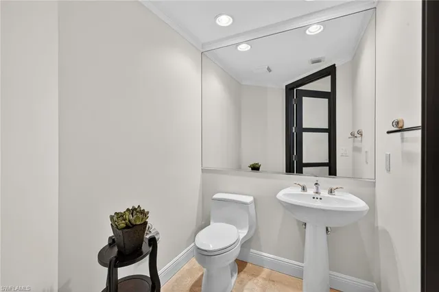 a bathroom with a sink toilet and a mirror