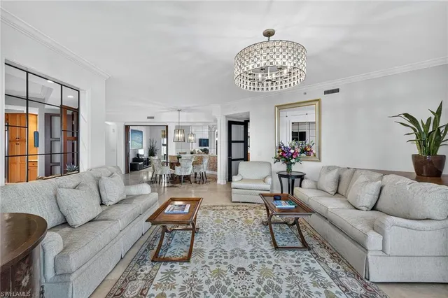 a living room with furniture or couch and a potted plant