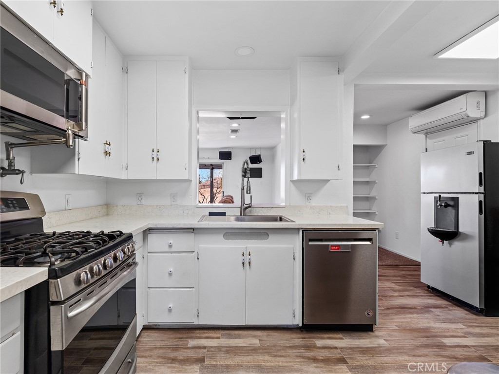 14060 Osage Road Apple Valley, CA 92307 - Photo 12 of 39 a kitchen with stainless steel appliances granite countertop a sink stove and refrigerator