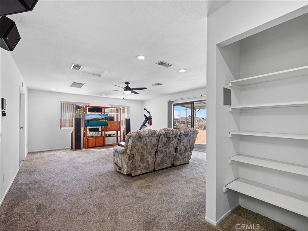 14060 Osage Road Apple Valley, CA 92307 - Photo 14 of 39 a living room with furniture and a flat screen tv