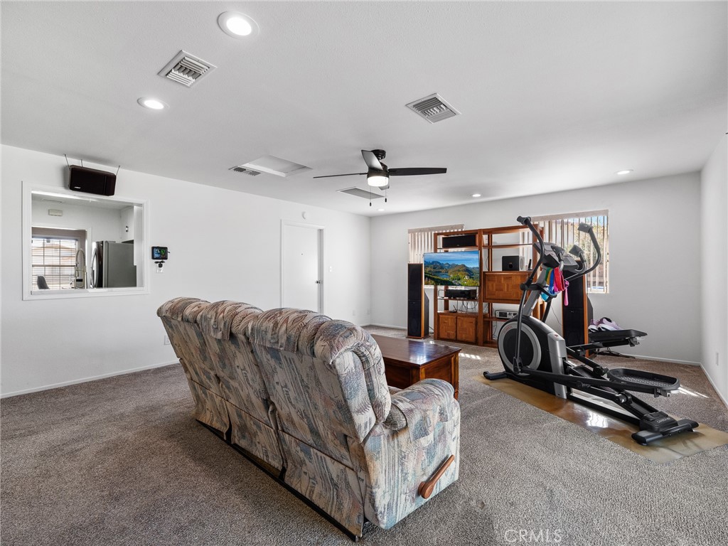 14060 Osage Road Apple Valley, CA 92307 - Photo 16 of 39 a living room with furniture and a gym equipment