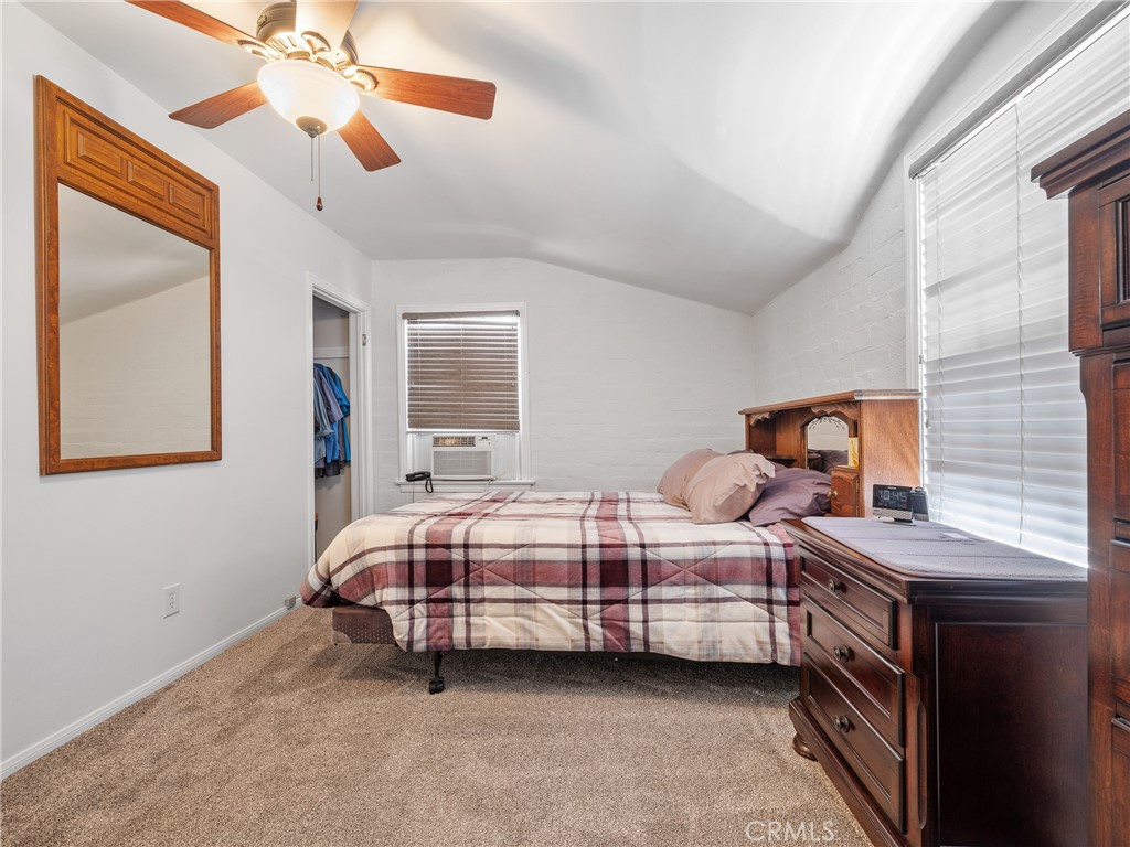 14060 Osage Road Apple Valley, CA 92307 - Photo 19 of 39 a bedroom with a bed and a chandelier