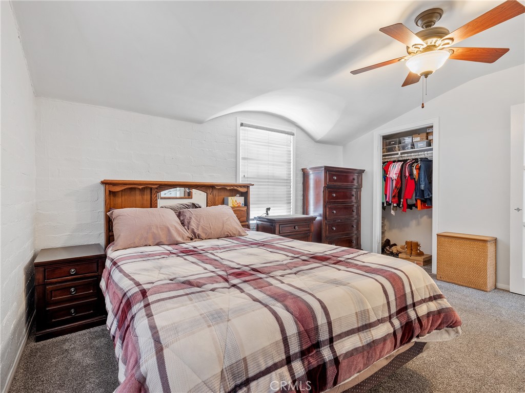 14060 Osage Road Apple Valley, CA 92307 - Photo 20 of 39 a bedroom with a bed and a chandelier