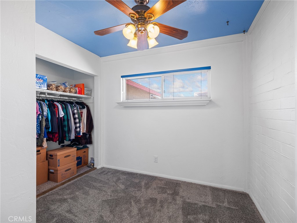 14060 Osage Road Apple Valley, CA 92307 - Photo 21 of 39 a view of walk in closet with clothes and shoes