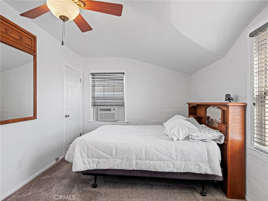 14060 Osage Road Apple Valley, CA 92307 - Photo 23 of 39 a bedroom with a bed and a large window