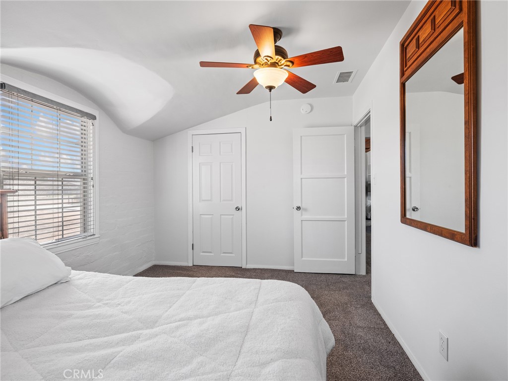 14060 Osage Road Apple Valley, CA 92307 - Photo 25 of 39 a bedroom with a bed and a chandelier