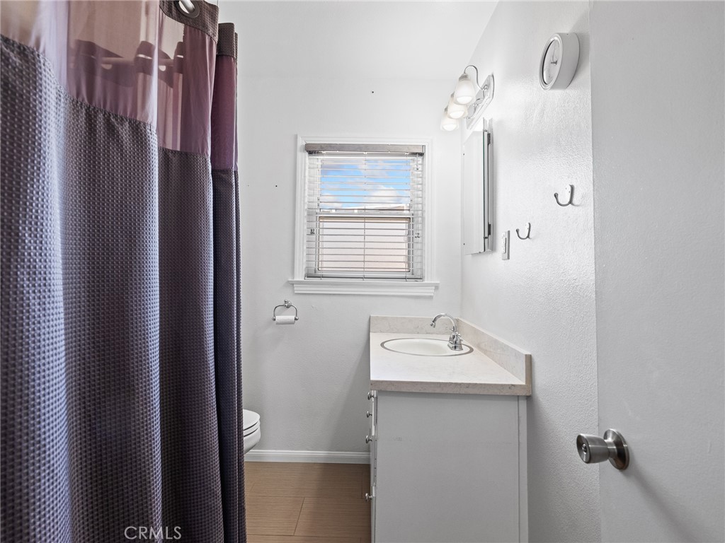 14060 Osage Road Apple Valley, CA 92307 - Photo 26 of 39 a bathroom with a sink a mirror a vanity and a shower