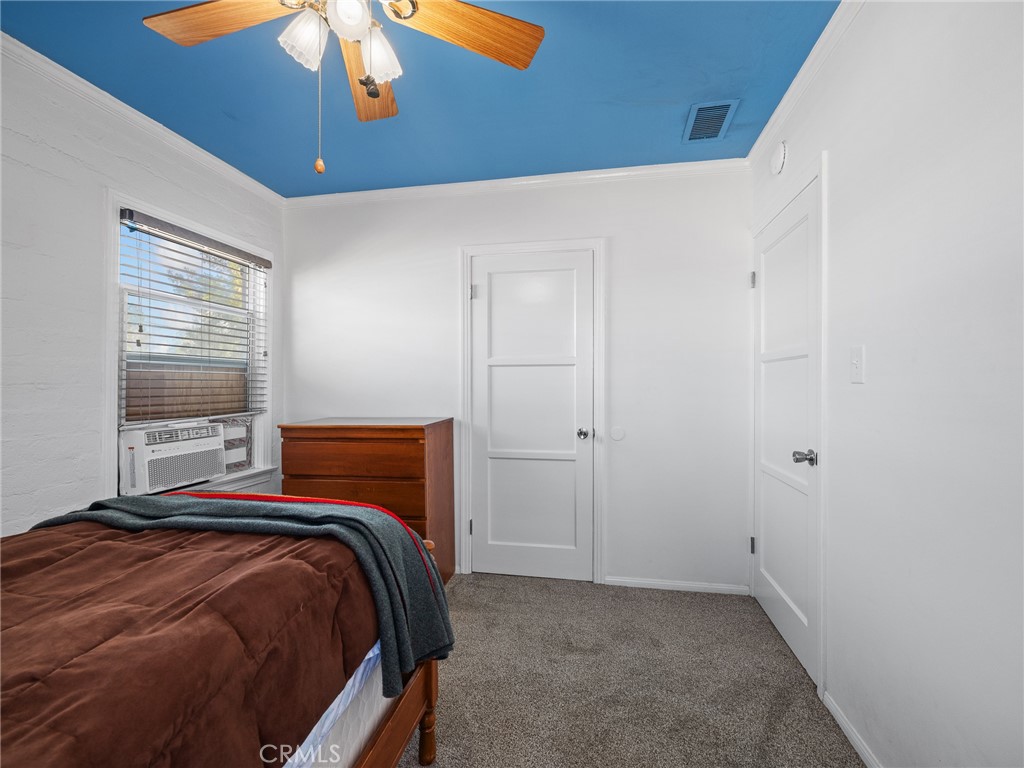 14060 Osage Road Apple Valley, CA 92307 - Photo 28 of 39 a bedroom with a bed and a chandelier
