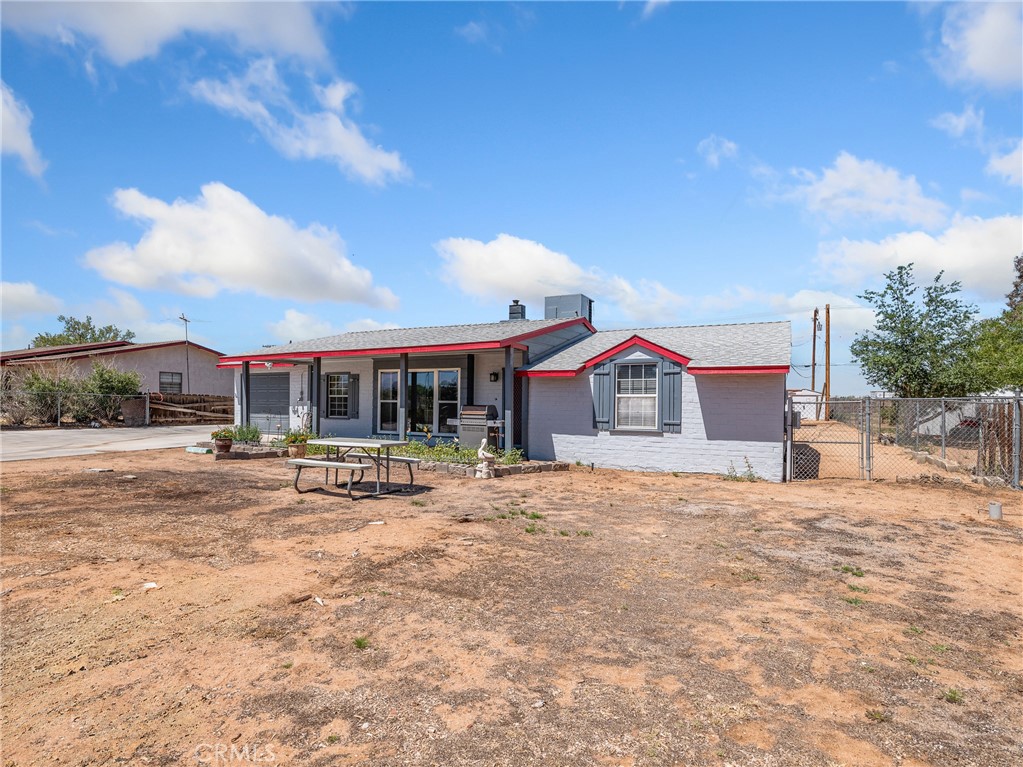 14060 Osage Road Apple Valley, CA 92307 - Photo 37 of 39 a view of a house with a yard and sitting area