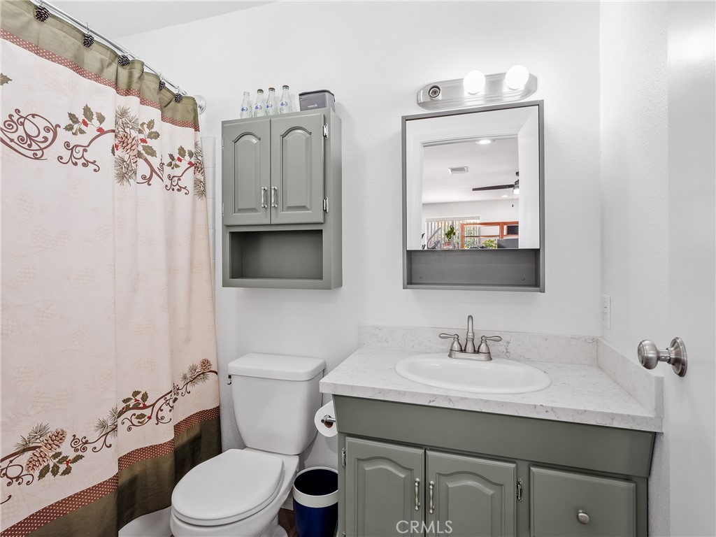 14060 Osage Road Apple Valley, CA 92307 - Photo 6 of 39 a bathroom with a toilet sink double vanity and mirror