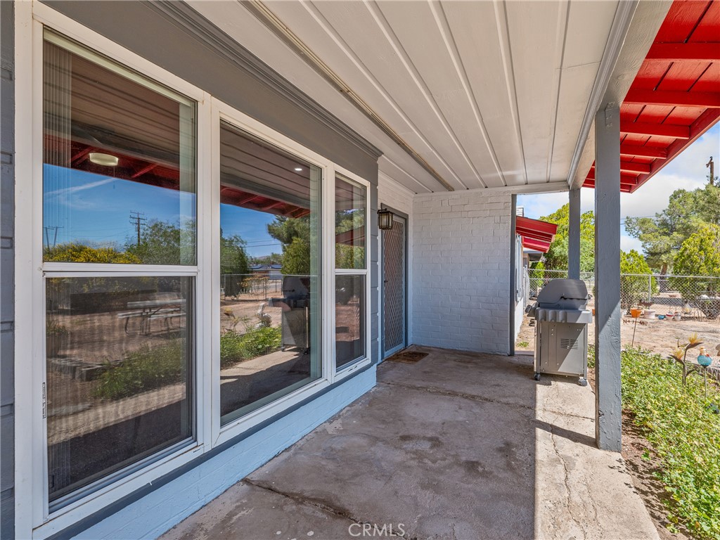 14060 Osage Road Apple Valley, CA 92307 - Photo 7 of 39 a view of a porch with furniture and front door