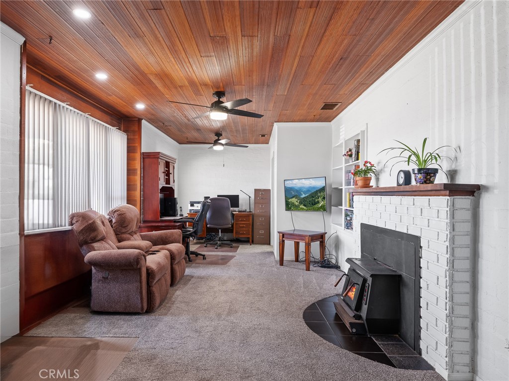 14060 Osage Road Apple Valley, CA 92307 - Photo 8 of 39 a living room with furniture and a fireplace