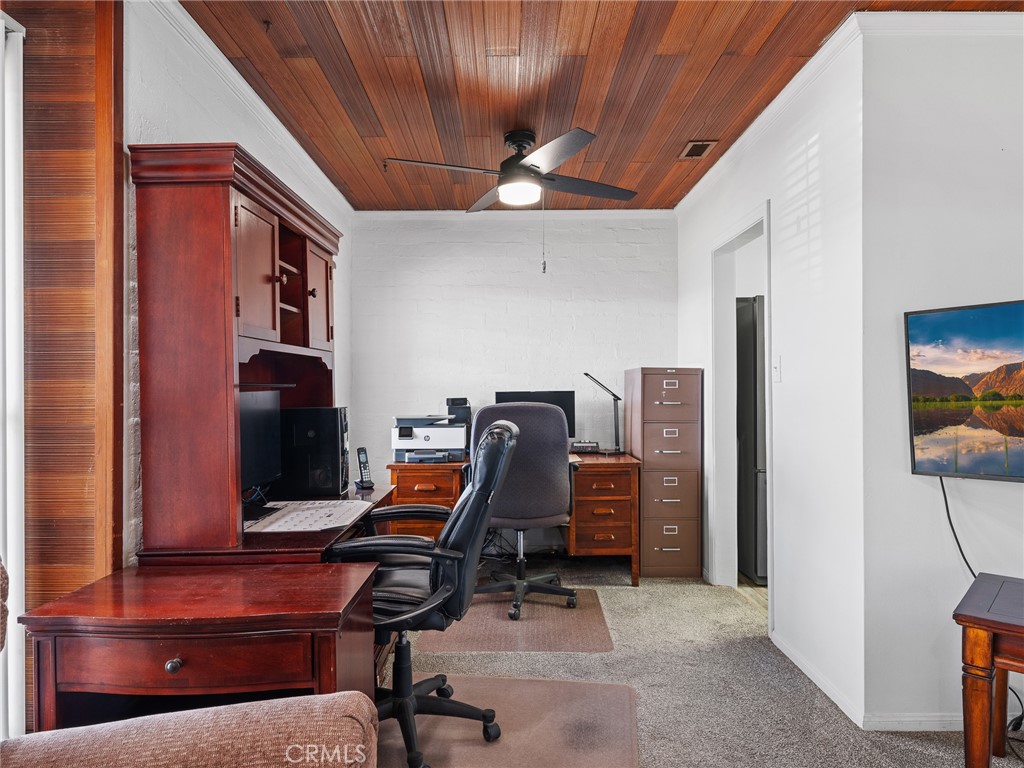 14060 Osage Road Apple Valley, CA 92307 - Photo 9 of 39 a view of a workspace with furniture and gym equipment