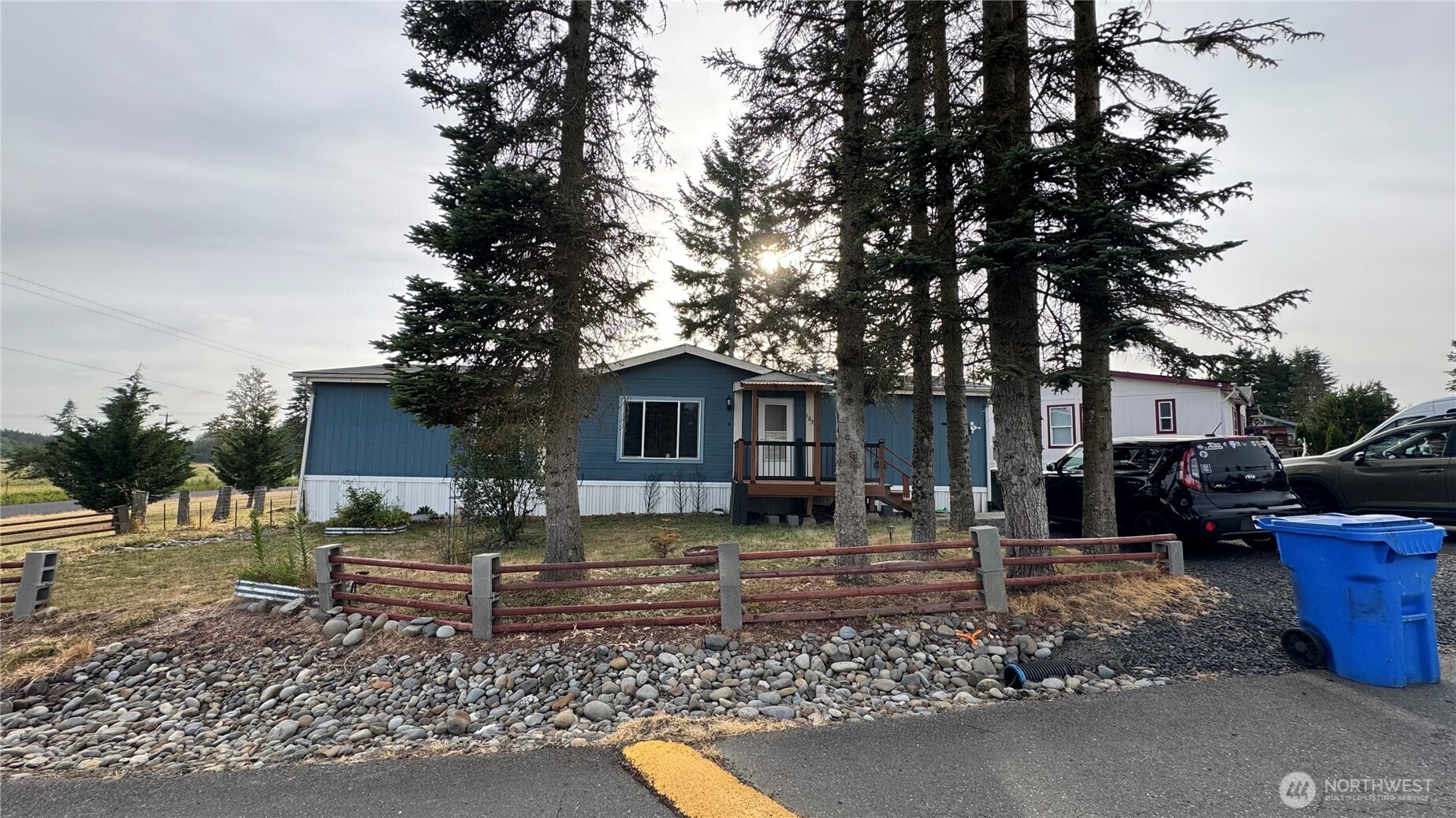 a backyard of a house with barbeque oven table and chairs