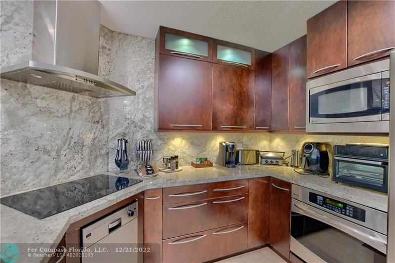 331 Southeast 4th Street Deerfield Beach, FL 33441 - Photo 12 of 37 a kitchen with stainless steel appliances a stove a sink and cabinets