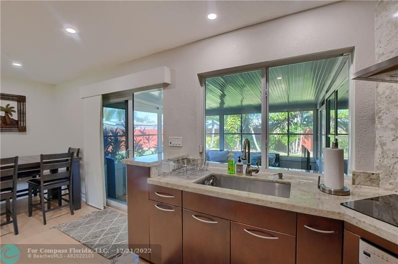 331 Southeast 4th Street Deerfield Beach, FL 33441 - Photo 13 of 37 a kitchen with stainless steel appliances granite countertop sink stove and cabinets
