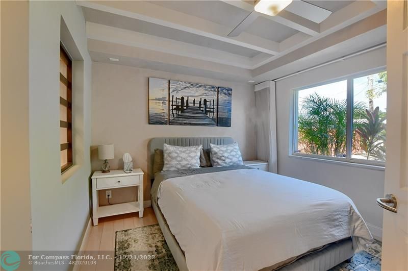 331 Southeast 4th Street Deerfield Beach, FL 33441 - Photo 15 of 37 a bedroom with a bed and a large window