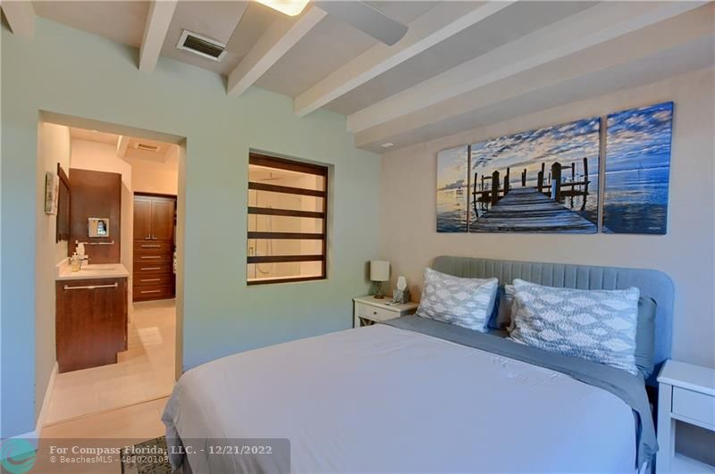 331 Southeast 4th Street Deerfield Beach, FL 33441 - Photo 17 of 37 a bedroom with a bed and a painting on the wall