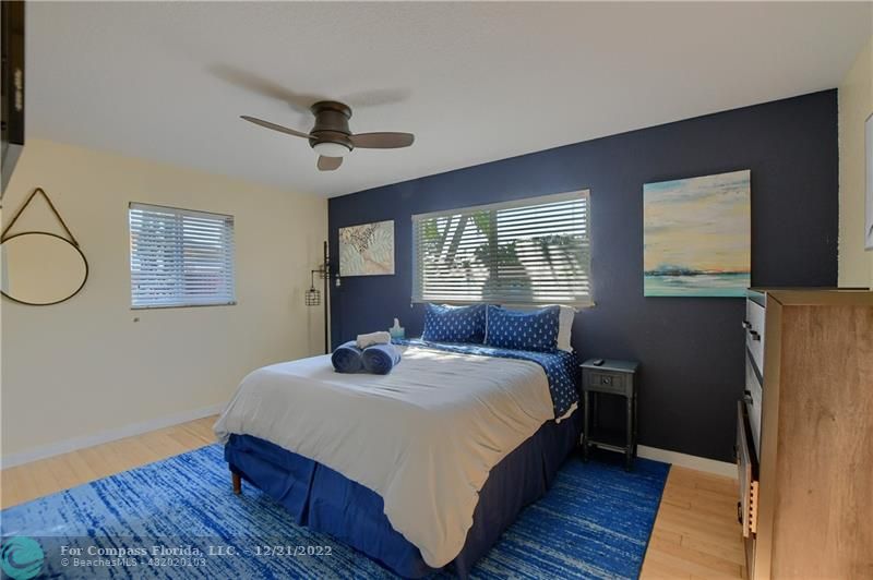 331 Southeast 4th Street Deerfield Beach, FL 33441 - Photo 23 of 37 a bedroom with a bed and wooden floor