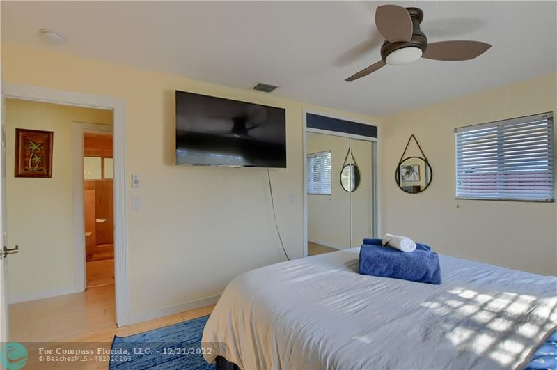 331 Southeast 4th Street Deerfield Beach, FL 33441 - Photo 25 of 37 a bedroom with a bed and a flat screen tv