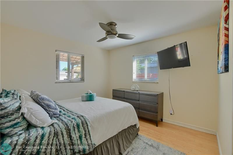 331 Southeast 4th Street Deerfield Beach, FL 33441 - Photo 28 of 37 a bedroom with a bed and a flat screen tv