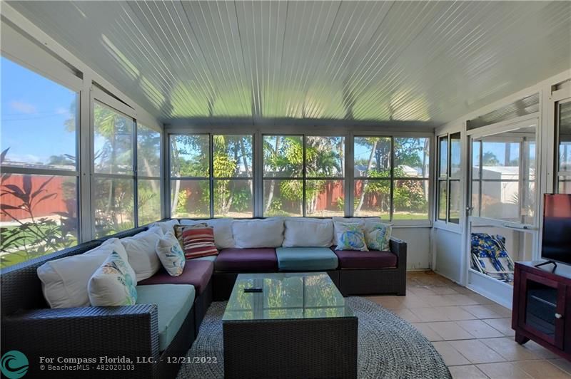 331 Southeast 4th Street Deerfield Beach, FL 33441 - Photo 30 of 37 a living room with furniture and a floor to ceiling window