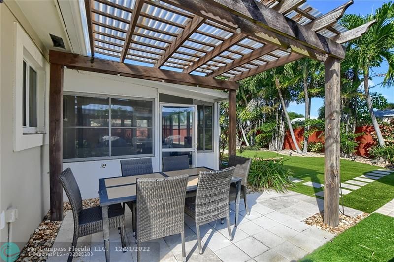 331 Southeast 4th Street Deerfield Beach, FL 33441 - Photo 32 of 37 a view of a patio with table and chairs and potted plants
