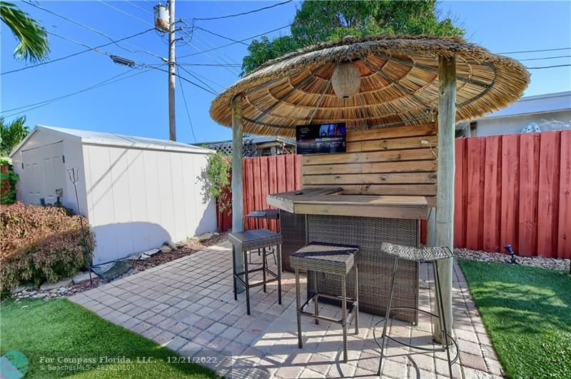 331 Southeast 4th Street Deerfield Beach, FL 33441 - Photo 34 of 37 a view of a chairs and table in the backyard