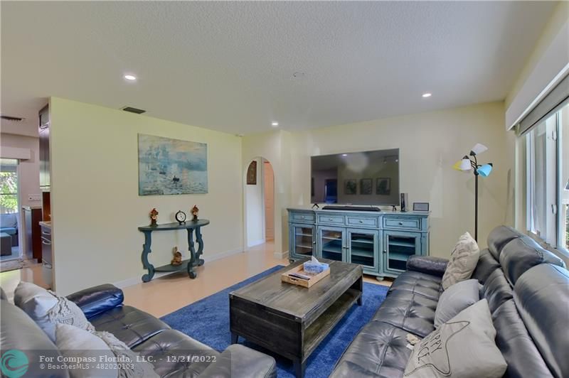 331 Southeast 4th Street Deerfield Beach, FL 33441 - Photo 5 of 37 a living room with furniture and a flat screen tv