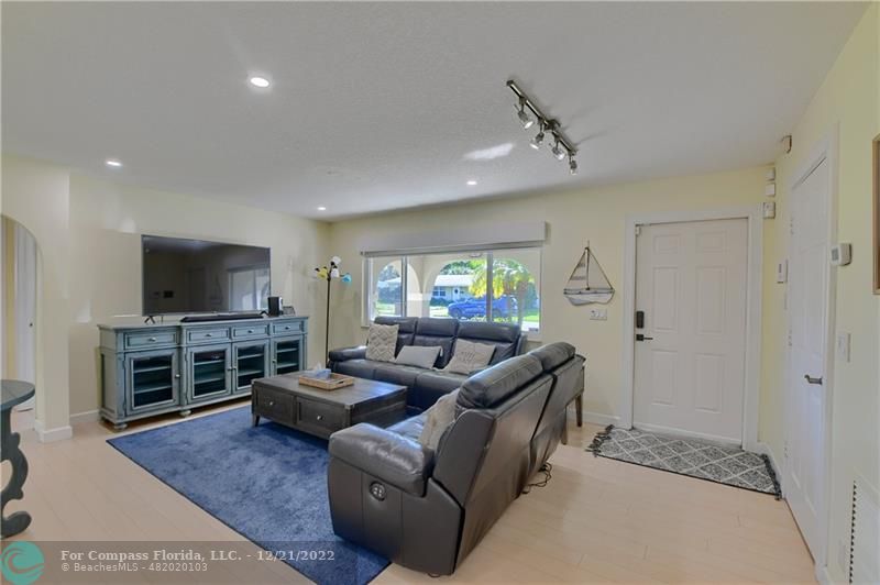 331 Southeast 4th Street Deerfield Beach, FL 33441 - Photo 6 of 37 a living room with furniture and a flat screen tv