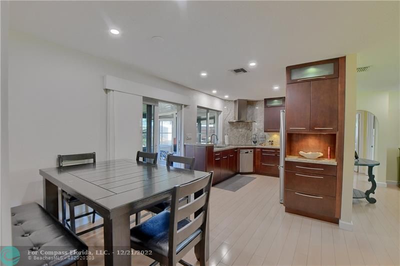 331 Southeast 4th Street Deerfield Beach, FL 33441 - Photo 9 of 37 a kitchen with a stove a refrigerator and a table