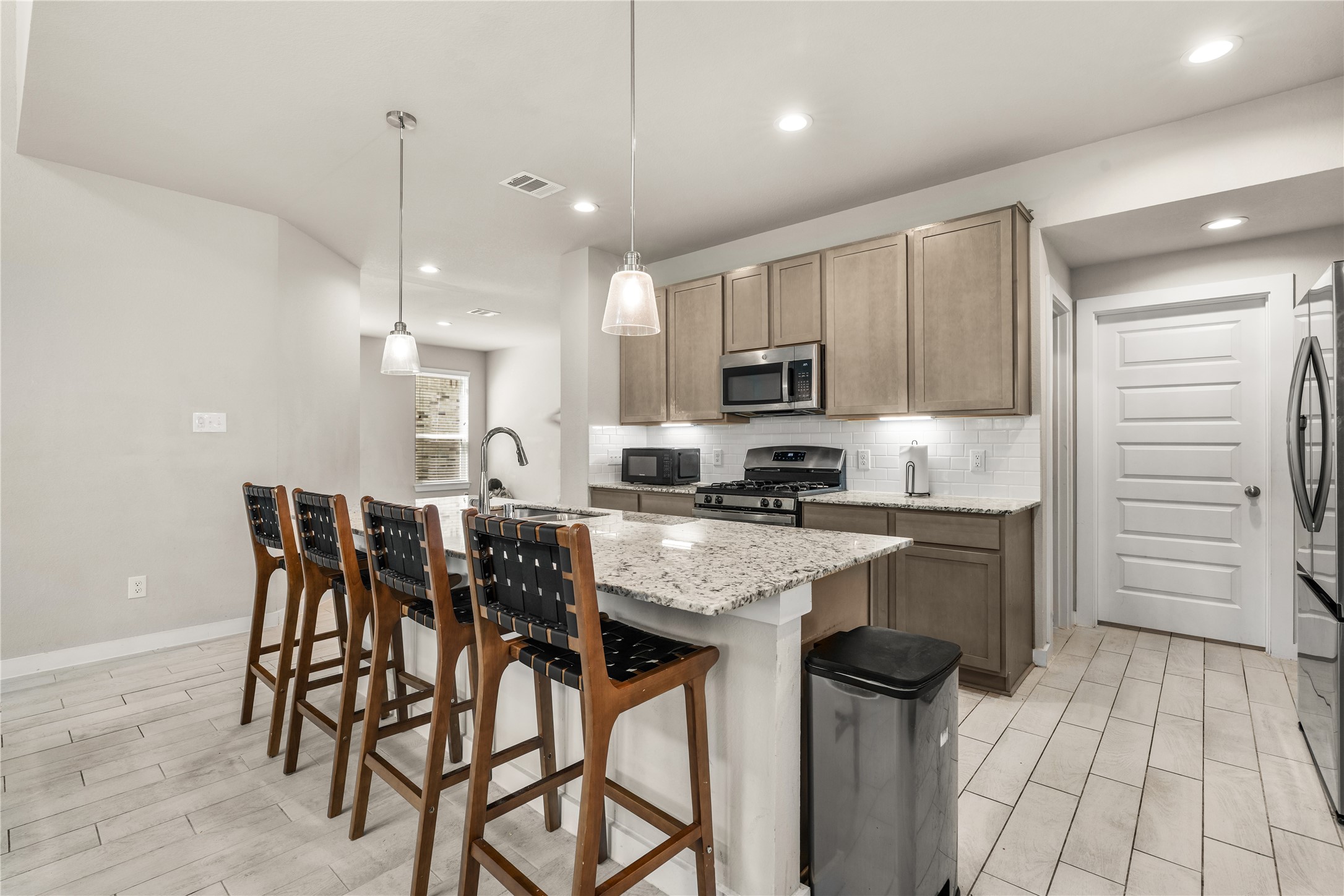 22939 Aspen Vista Dr Spring Spring, TX 77373 - Photo 7 of 29 Whether hosting guests or enjoying a quiet morning, this inviting kitchen combines a large center island, generous prep space, and an open design built for the way you live.