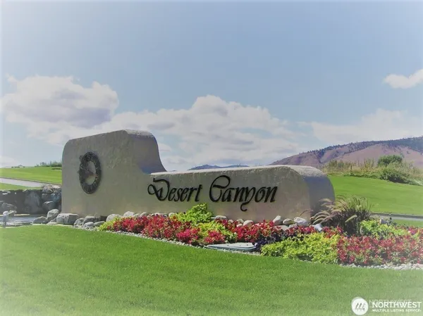 a sign that is in front of flowers