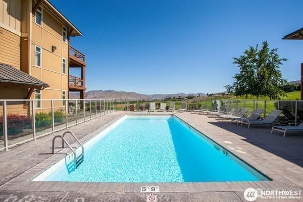 a view of a swimming pool with a lounge chair