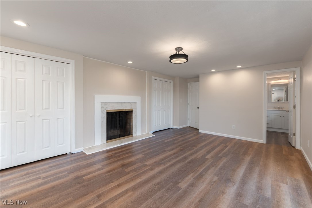 13295 Sperry Road Chesterland, OH 44026 - Photo 21 of 35 Unfurnished living room featuring dark hardwood / wood-style floors and a fireplace