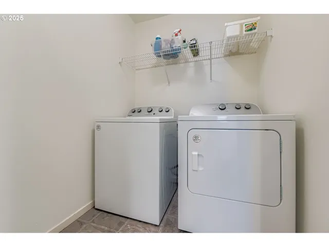 a view of a deck with chairs and wooden fence