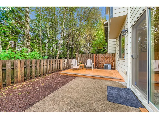 a backyard of a house with garden barbeque oven and outdoor seating