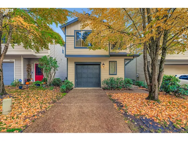 a front view of a house with a yard and a garage