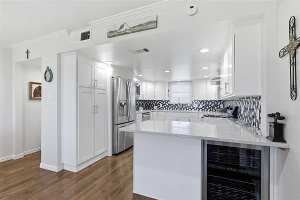 a view of a kitchen with a sink and refrigerator