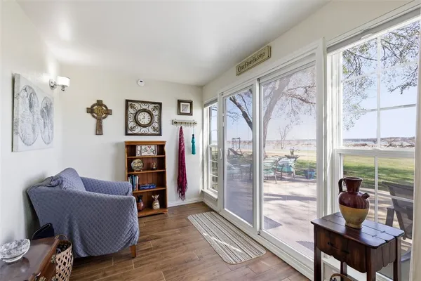 a living room with furniture and a floor to ceiling window
